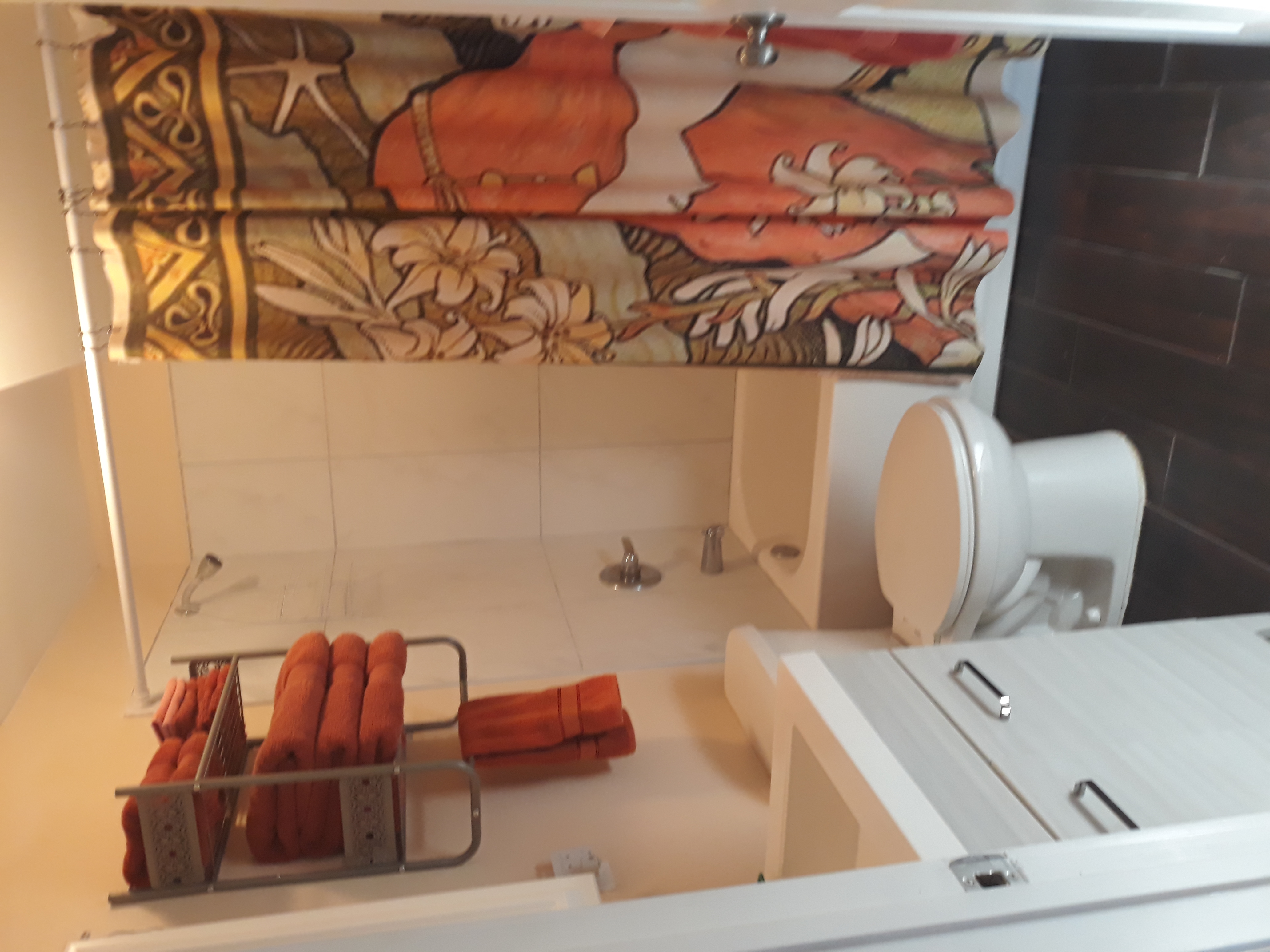 A full sink, tall toilet, and full bath with shower.